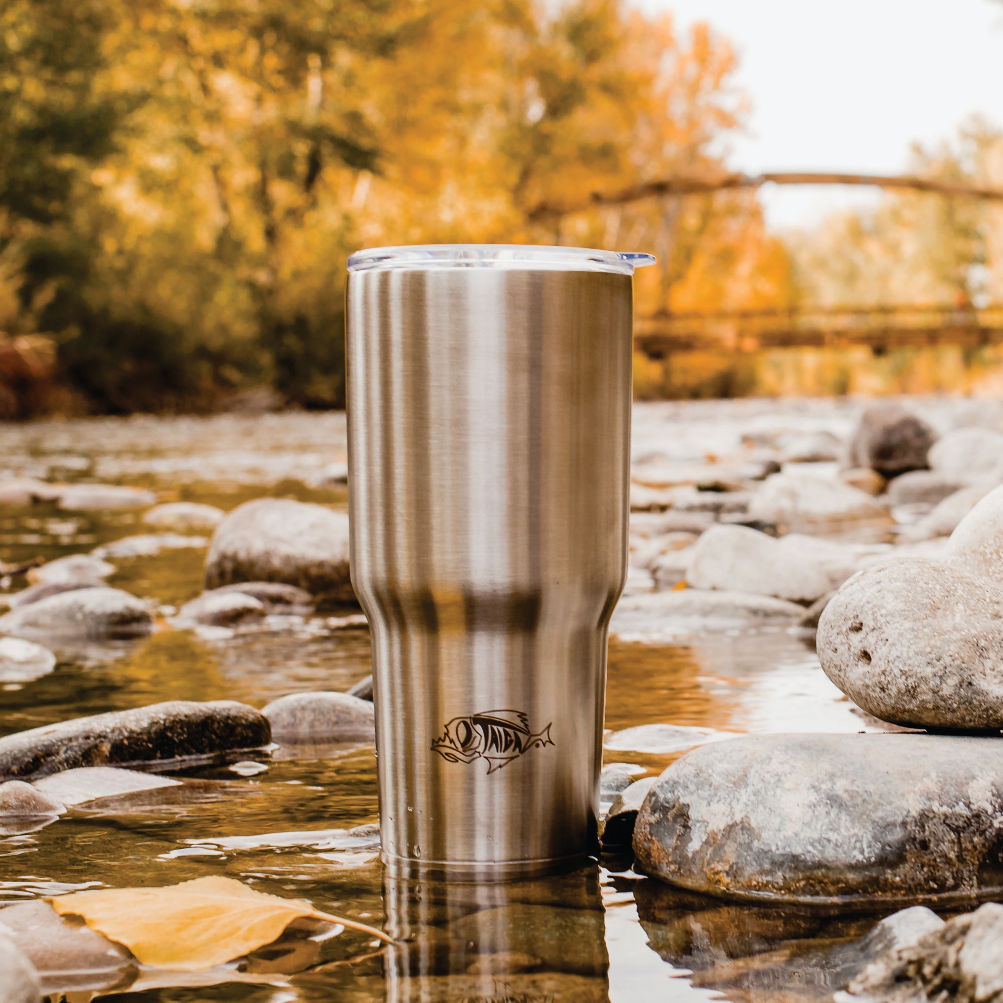 Taiga 30 Ounce tumbler in a creek near a bridge
