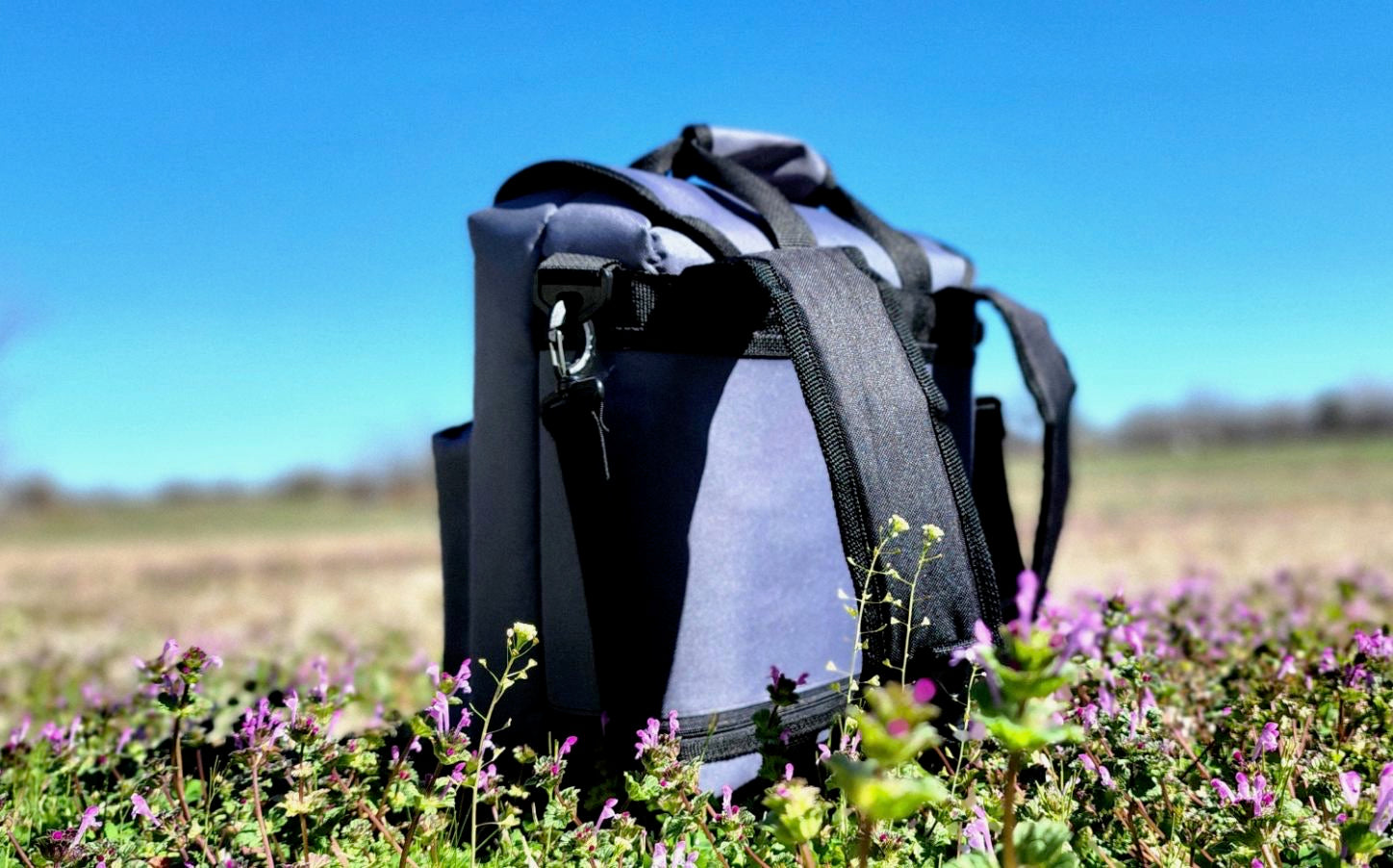 back pack cooler sitting in a field